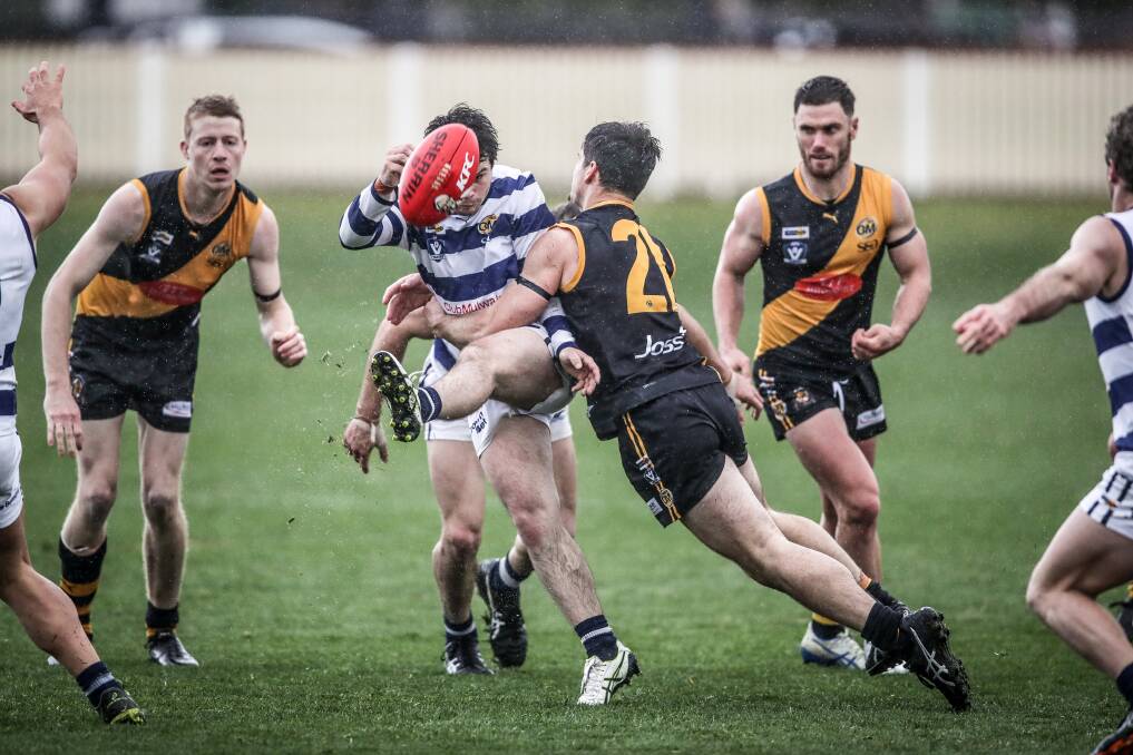 CRUNCH: In the wet conditions, there were plenty of collisions with Albury's Joel Mackie tackling Pigeon Brayden Coburn. Picture: JAMES WILTSHIRE