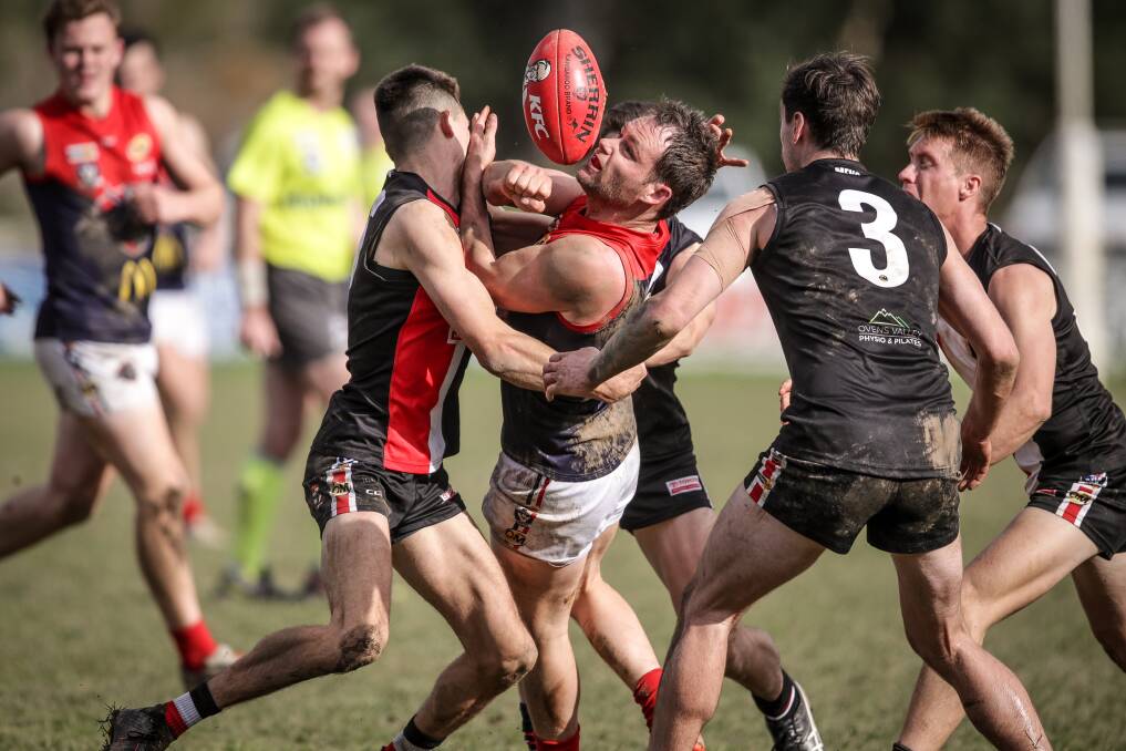 TOUGH STUFF: Wodonga Raiders' Jarrod Hodgkin is surrounded, but still gets the ball away against Myrtleford. Picture: JAMES WILTSHIRE
