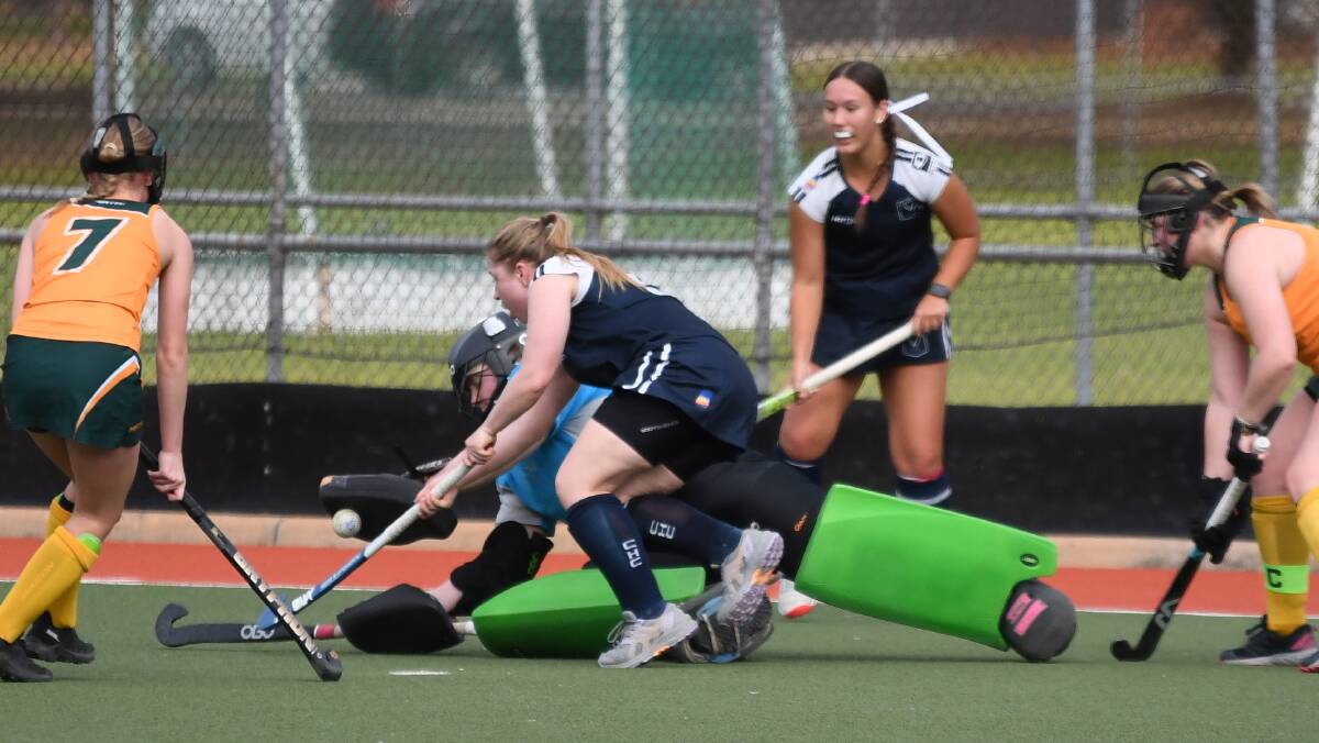Spitfires' goalkeeper Georgia Martin makes a spectacular save. Picture by Hockey Albury Wodonga