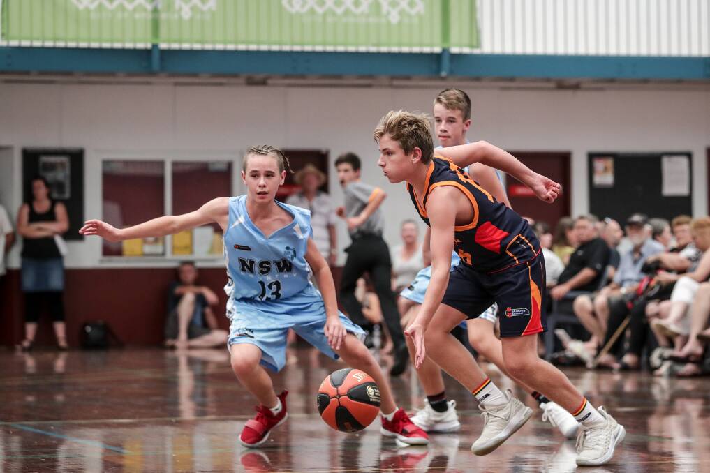 MAC ATTACKS: South Australia's Mitchell McDonald looks to work his way through the defence of the NSW Kookaburras at under 14 level.

