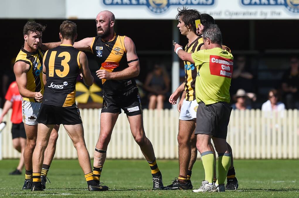 YOU'RE OFF: Wangaratta Rovers' Stuart Booth (left) receives his marching orders from the umpire in Saturday's clash. Picture: MARK JESSER
