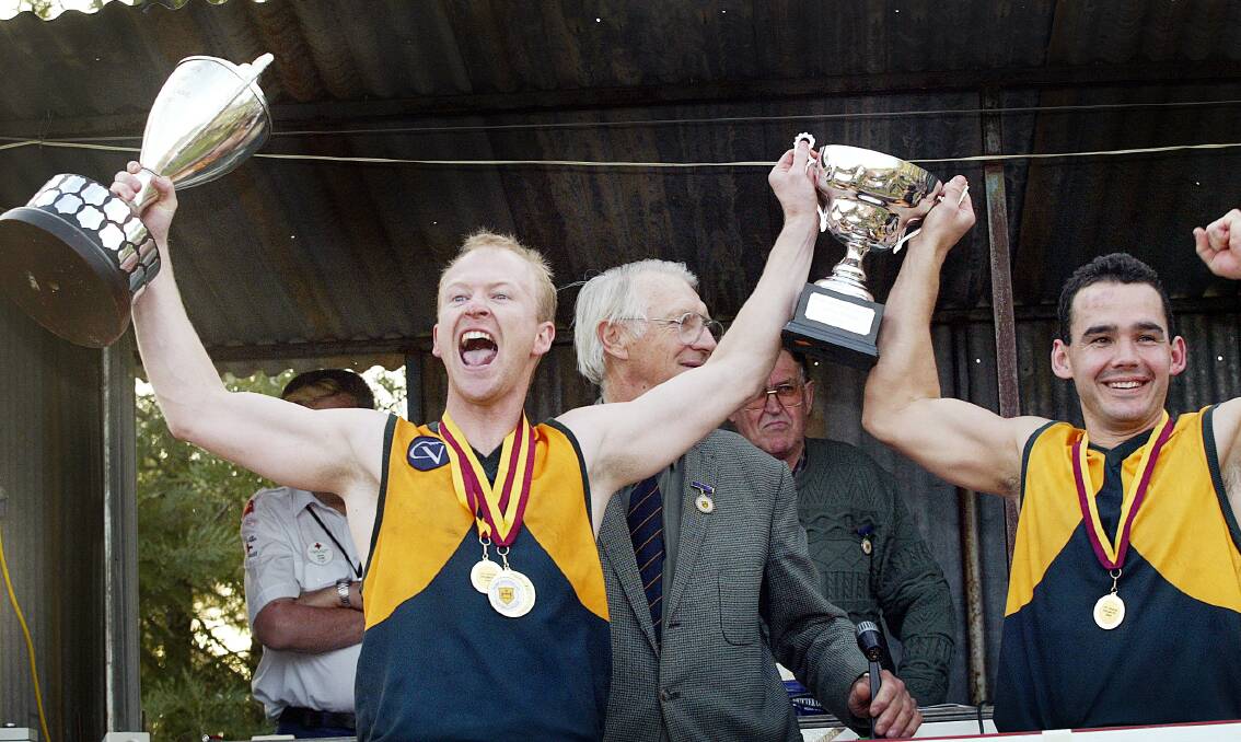 Holbrook coach Marc Duryea with the premiership cup and was also awarded the Des Kennedy medal for best on ground alongside Marty Semmler who was skipper.