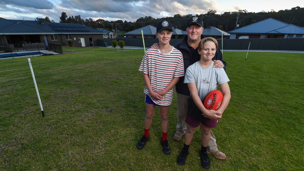 PROUD DAD: Jason McInnes with his sons Wil, 14 and Jay, 11. Picture: MARK JESSER