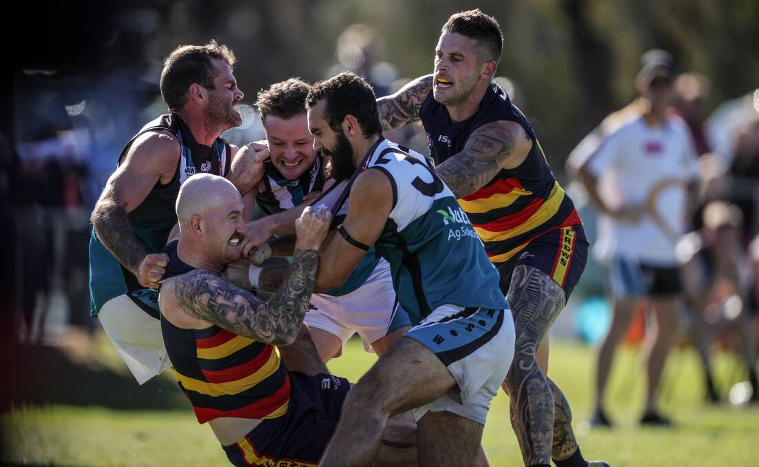 SCUFFLE: Billabong Crows forward Kristopher Willett feels the heat from the oppostion.