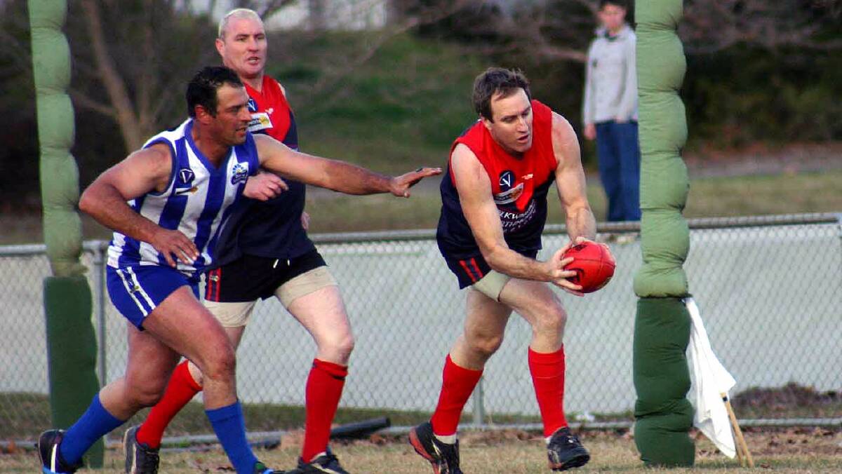 SAFE HANDS: Mack takes a mark for Corryong against Tumbarumba. Mack coached his home club to the flag in 2001.