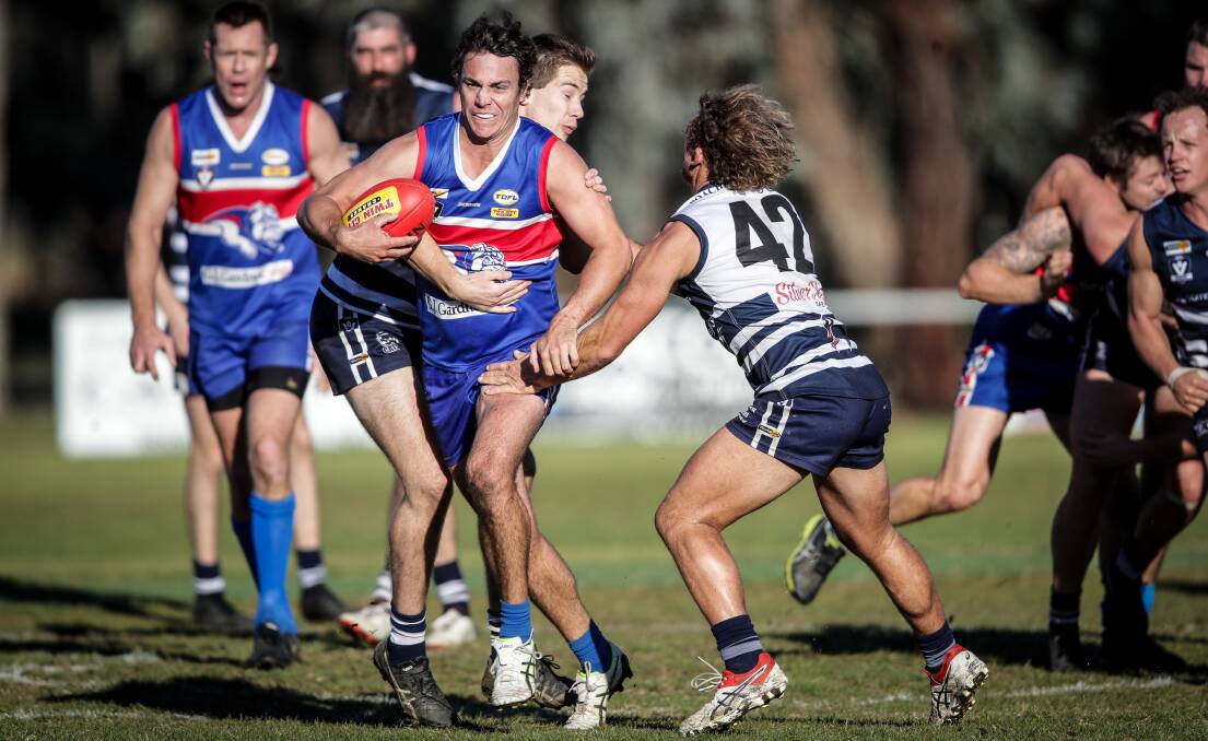 COMING THROUGH: Thurgoona coach Brett Doswell tries to burst through against Rutherglen recently.