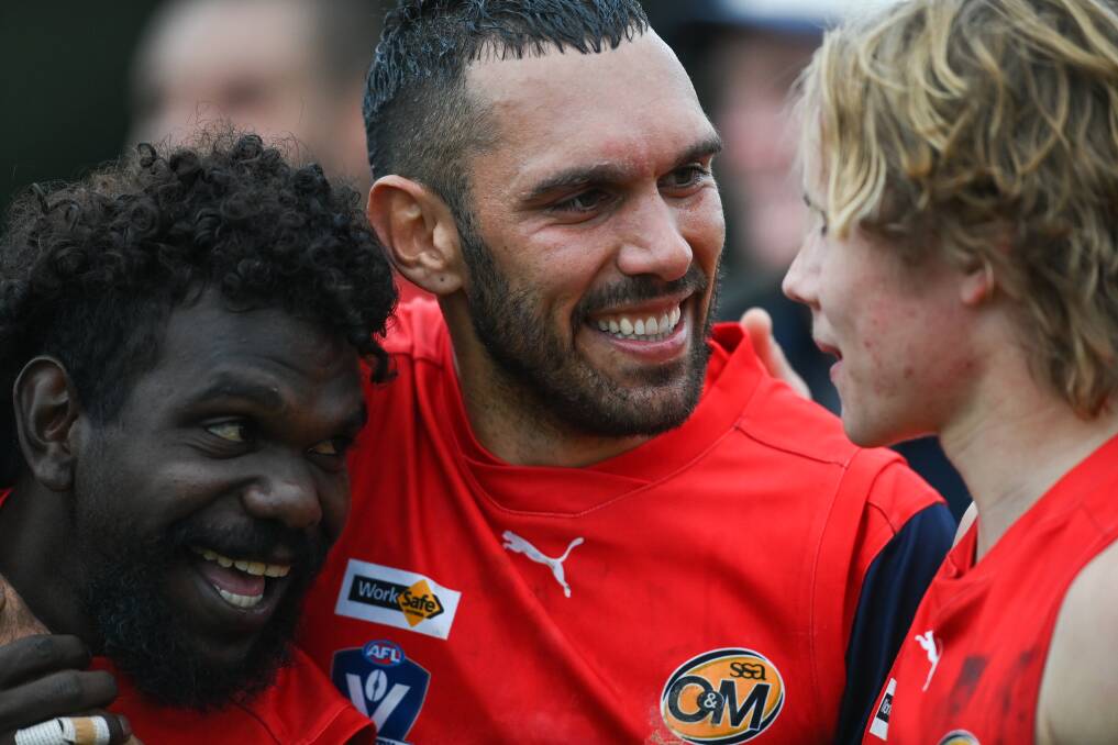 Bennell celebrates with teammates the Raiders' round 8 win over Myrtleford last season.