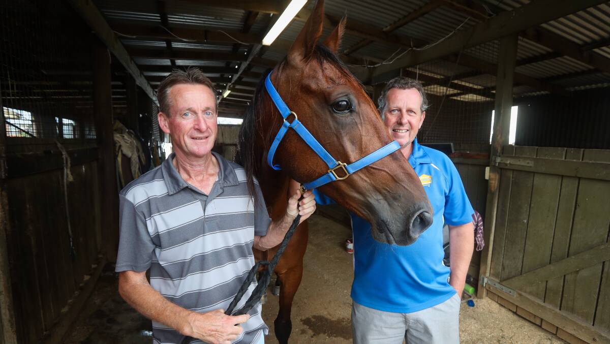GRINNING OWNERS: Glenn Teesdale and Craig English are among the part-owners of Grinning Punter who resumes from a lengthy lay-off at the Albury Paceway on Tuesday night.