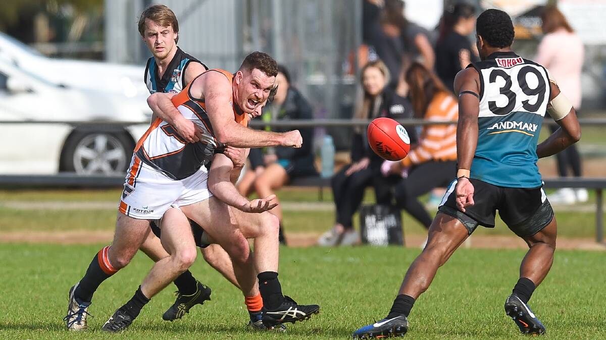 UNDER PRESSURE: Rand-Walbundrie-Walla's Jack Duck is wrapped-up in a tackle against CDHBU on Saturday. Picture: MARK JESSER