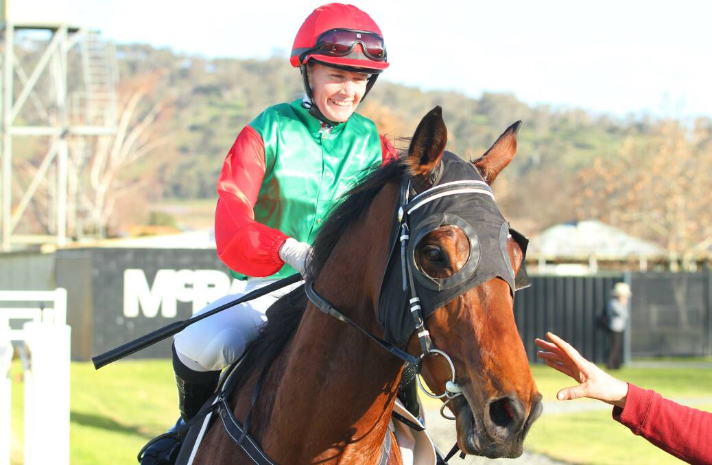 ALL SMILES: Apprentice jockey Mikaela Lawrence returns to scale aboard the Peter Maher-trained Flying Cyril at Wodonga yesterday. Flying Cyril is a handy performer with more than $100,000 in prizemoney. Picture: RACING PHOTOS