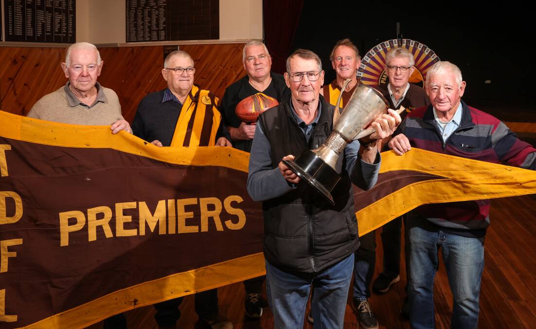 PARTY TIME: Bob Whitehead with the cup with premiership team-mates Ray Rolfe, David Sutherland, Paul Lonergan, Vin ONeill, Terry Barber and Ken Coulston. Pictures: JAMES WILTSHIRE