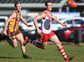 BIG SWAN: Chiltern's Kyle Magee lead's Kiewa-Sandy Creek's Jack Andrew in the battle to gain possession at Tangambalanga on Saturday. Picture: MARK JESSER