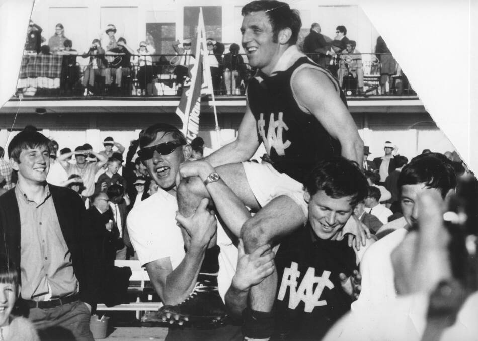 Mick Bone is chaired off the ground.