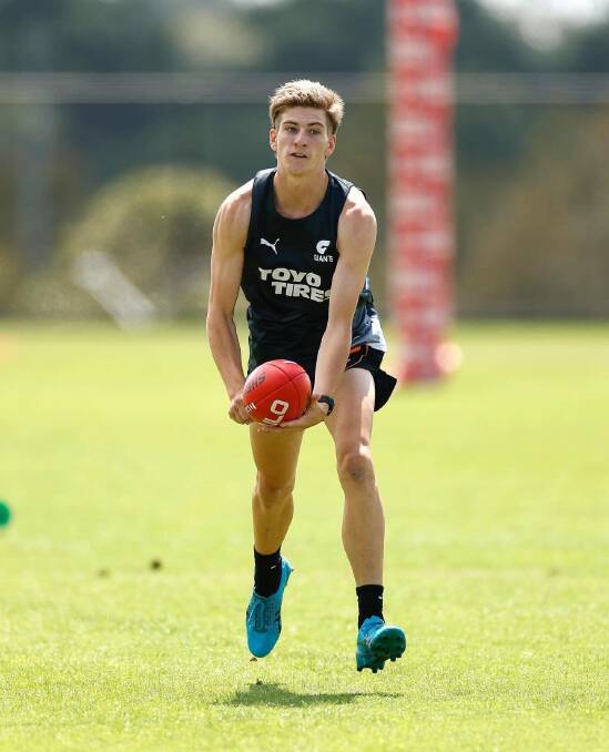 Wardius fires off a handball at his first training run with GWS Giants on Monday.