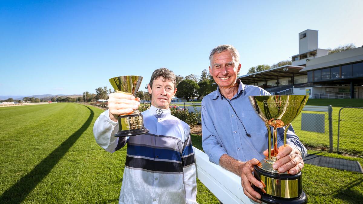 GOLDEN MOMENT: Mathew Cahill and Ron Stubbs with the spoils of victory. Picture: JAMES WILTSHIRE