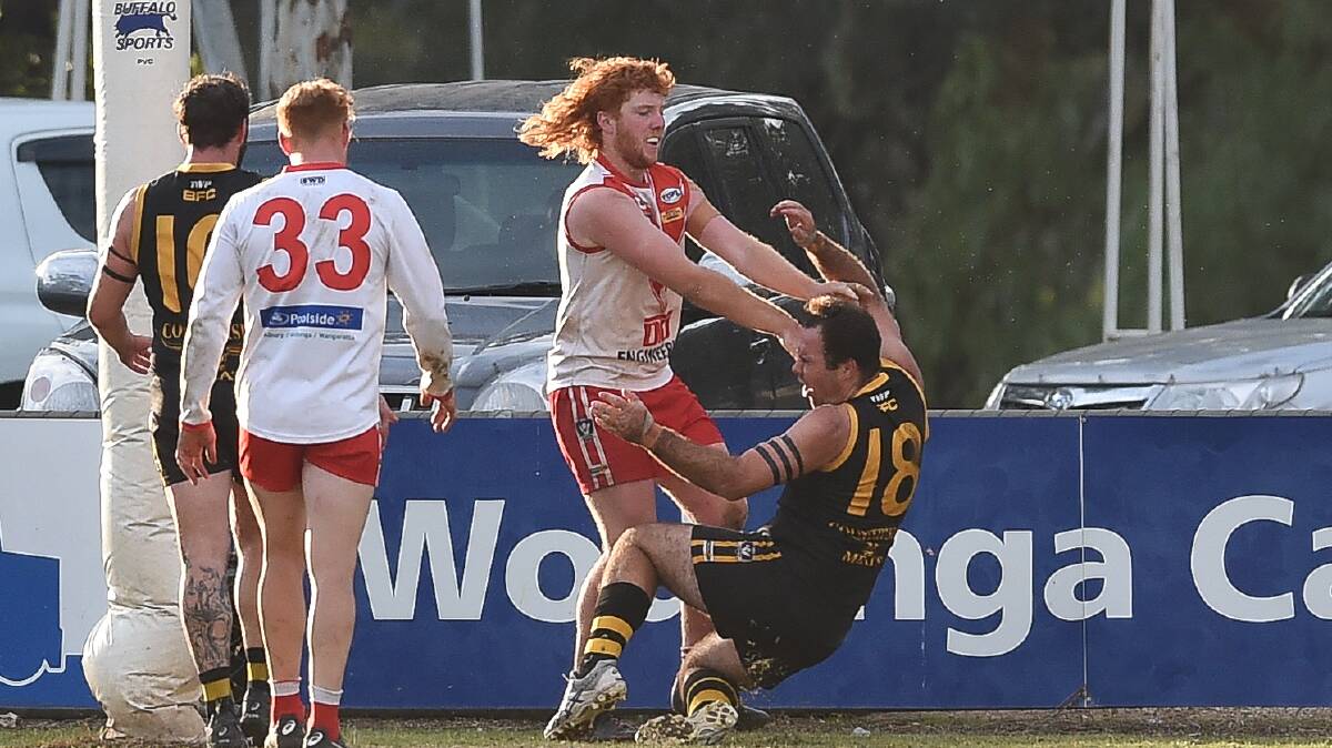 DON'T ARGUE: Chiltern's Brodie Oates shows Barnawartha coach Peter Cook who's boss. Picture: MARK JESSER