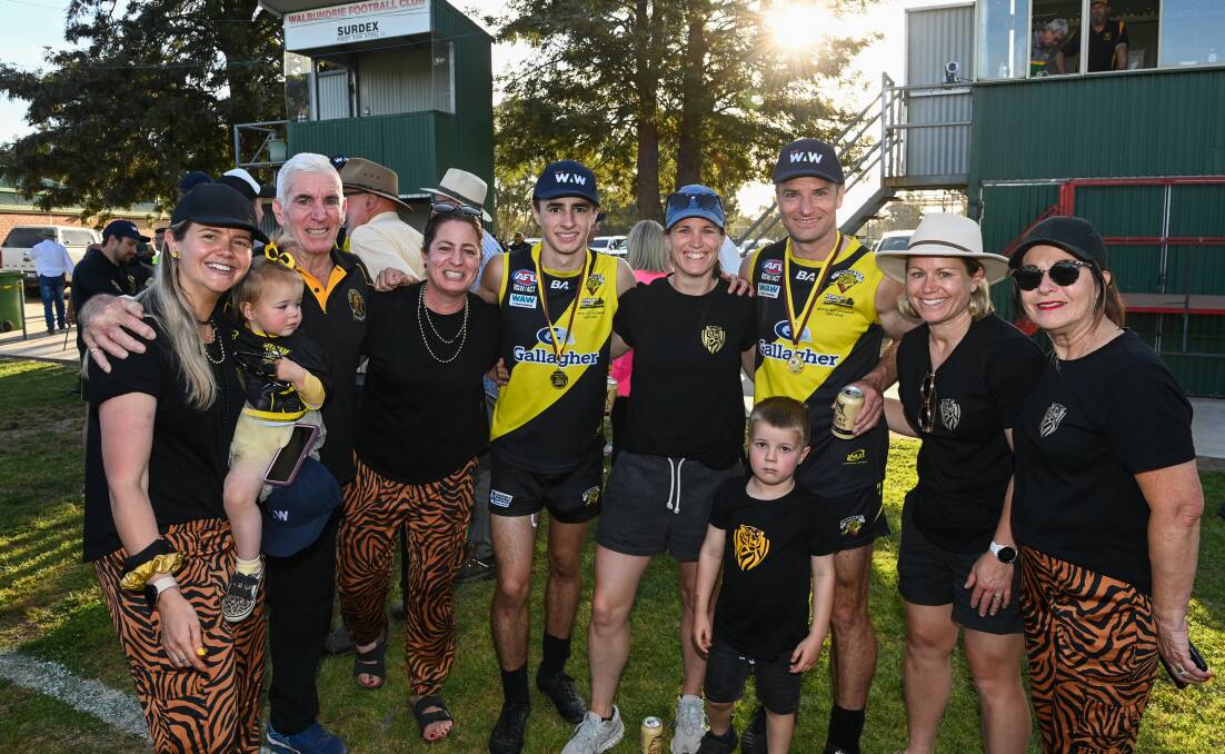 Mackie shares a special moment with his family after the Tigers' grand final triumph over Holbrook. Picture by Mark Jesser