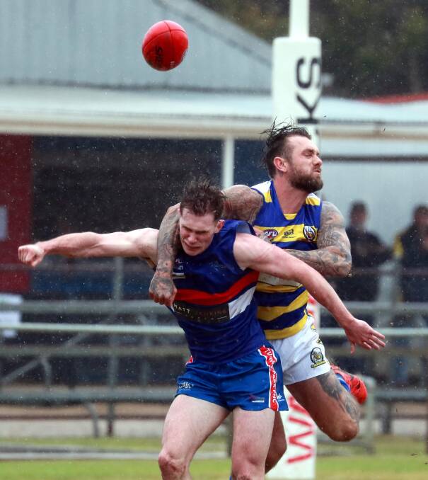 IMPRESSIVE DEBUT: Trent Castles and Turvey Park's James Pope contest a mark in the slippery conditions at Maher Oval on Saturday. Picture: DAILY ADVERTISER