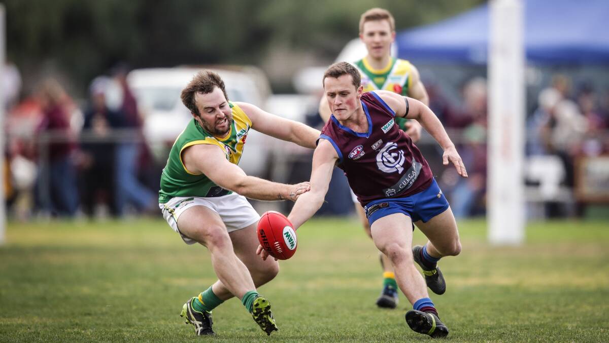 ON A STRING: Culcairn's Ben Gould leads Holbrook's Jayden Beaumont in the race for the ball at Culcairn on Saturday. Picture: JAMES WILTSHIRE