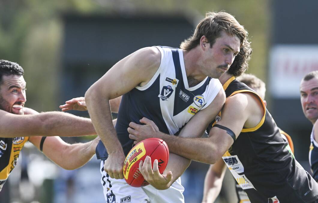 Mitta United's Lachie Peters cops plenty of pressure from the Tigers at Barnawartha on Saturday. Picture by Mark Jesser