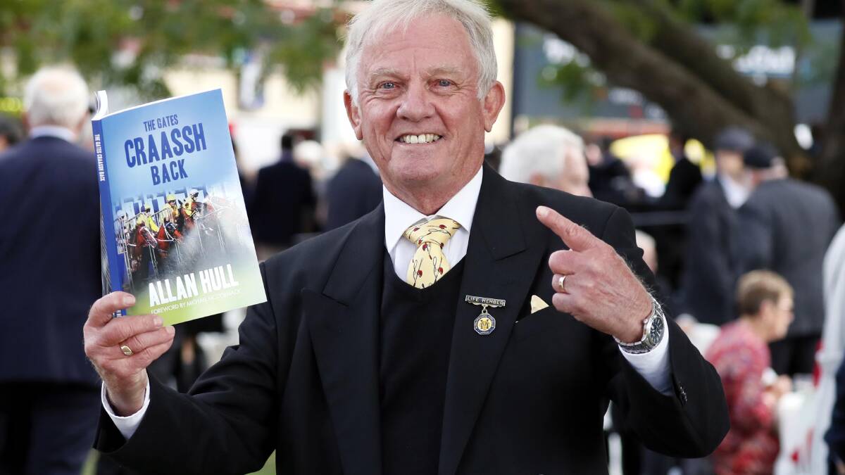 ONE OF A KIND: Retired racecaller Allan Hull shows off his autobiography 'The Gates Craassh Back' that he launched at the Wagga Gold Cup. Picture: DAILY ADVERTISER