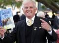 ONE OF A KIND: Retired racecaller Allan Hull shows off his autobiography 'The Gates Craassh Back' that he launched at the Wagga Gold Cup. Picture: DAILY ADVERTISER