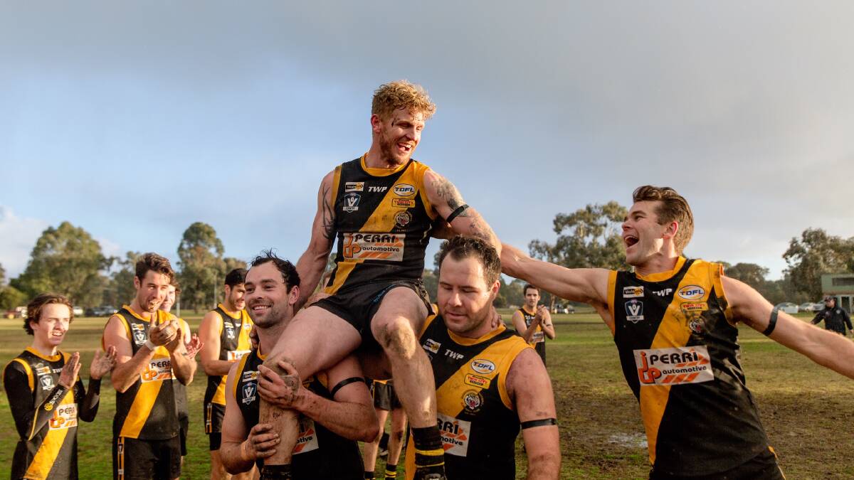 Cameron McNeill is chaired off the ground after playing his 200th match for Barnawartha last weekend. Picture: SARA RENDELL