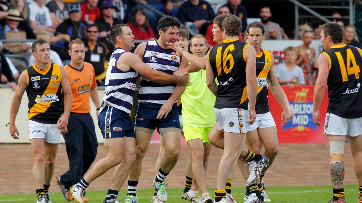 ROUGHED UP: Brendan Fevola and Michael Thompson exchange barbs in the 2013 decider.