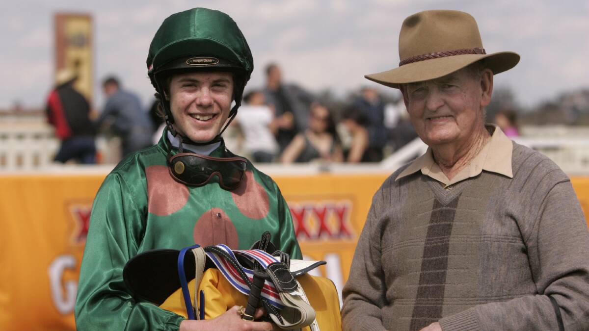 HAPPIER TIME: John Kissick with Leeton trainer Peter Clancy in 2010.
