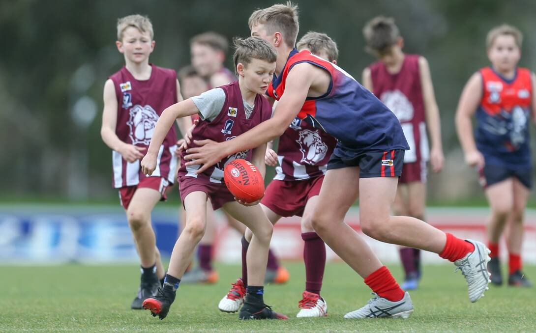 UNDER PRESSURE: Wodonga's Ryan Piper is tackled by Wodonga Raiders' James Glass in an under-12 practice match on Sunday at Birallee Park. Pictures: TARA TREWHELLA