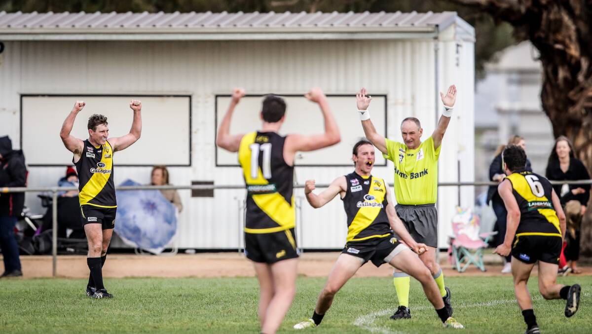 PARTY TIME: Matt Rava (far left) raises his arms in jubilation after the final siren sounded against Brock-Burrum on Saturday.