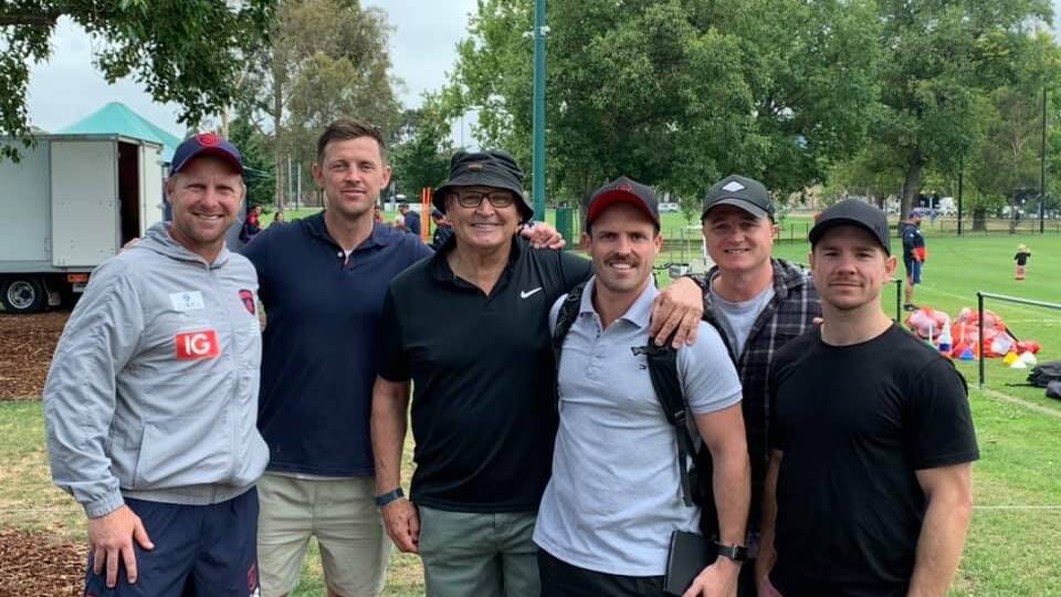 Melbourne assistant coach Justin Plapp with Tim Kennedy, Jeff Gieschen, Tyson Smith, Tom Russell and Joel O'Connell at Melbourne's training session on Monday.