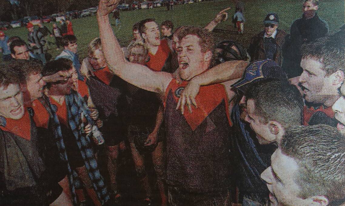 The Demons celebrate their 2001 flag triumph.