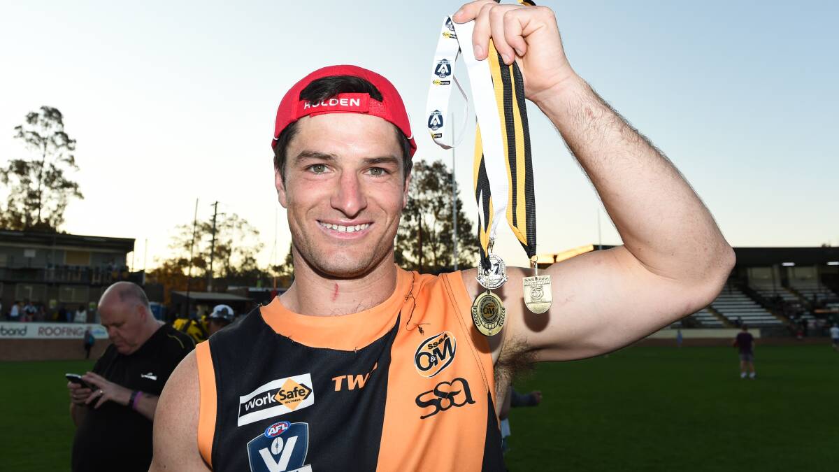 BEST ON GROUND: Mackie with his premiership medallion and Did Simpson medal for best on ground in 2014.