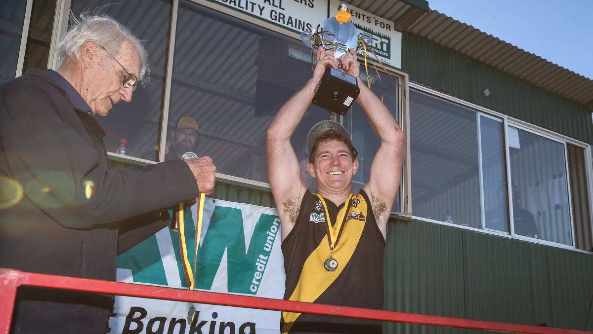 PREMIERS: Matt Rava holds the 2017 premiership cup aloft. Rava is most likely to step down as coach at the end of the season.