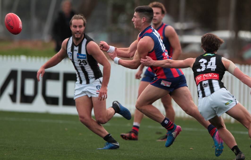 New Yarrawonga recruit Perry Lewis-Smith in action for Port Melbourne against Collingwood with North Albury coach Tim Broomhead playing for the Pies.