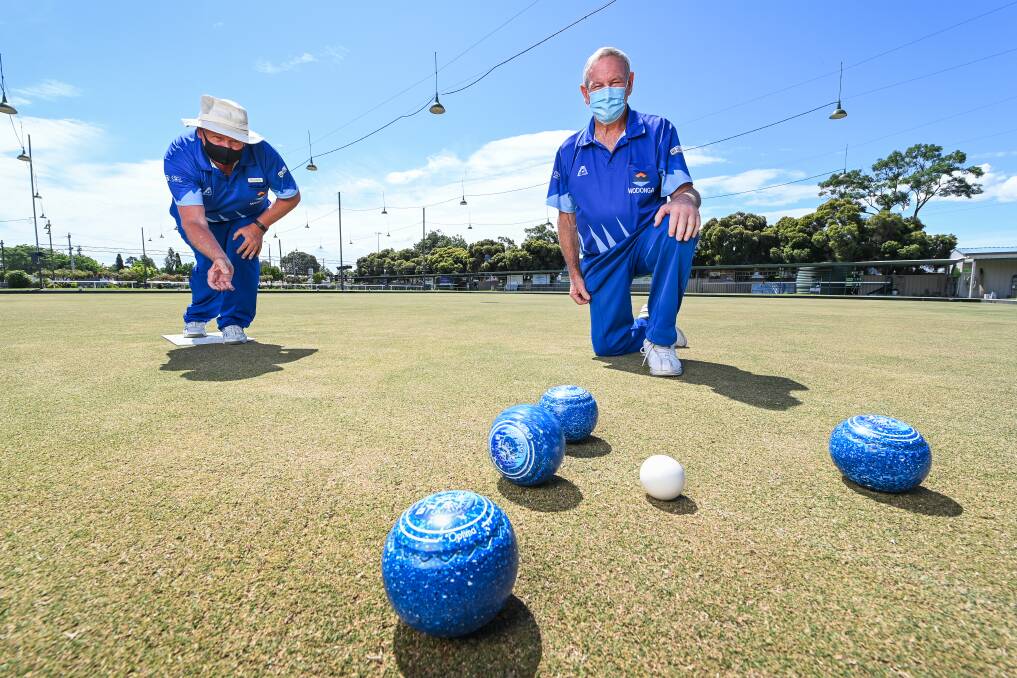 BEHIND THE MASK: Wodonga Bowling Club's David Sully and Noel Murrell know it will be a bowls season like no other for Ovens and Murray clubs. Picture: MARK JESSER