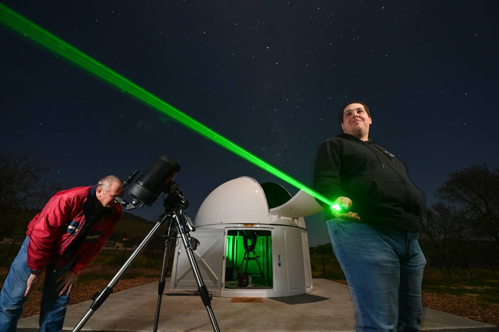 SKY HIGH: Tallangatta and District Astronomy Club's Zachary West (right) and Wayne Middleton make the most of a clear night. Picture: MARK JESSER
