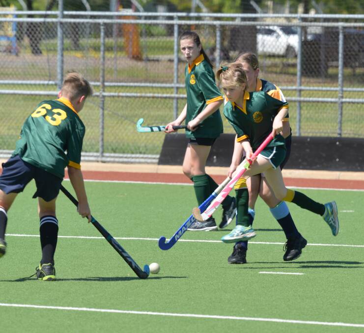 WE HAVE LIFTOFF: Scarlett Meyer seems to be flying as she rushes to tackle Daniel Proos during the weekend's Hockey Albury-Wodonga junior eights action: Picture: NARELLE HAMILTON