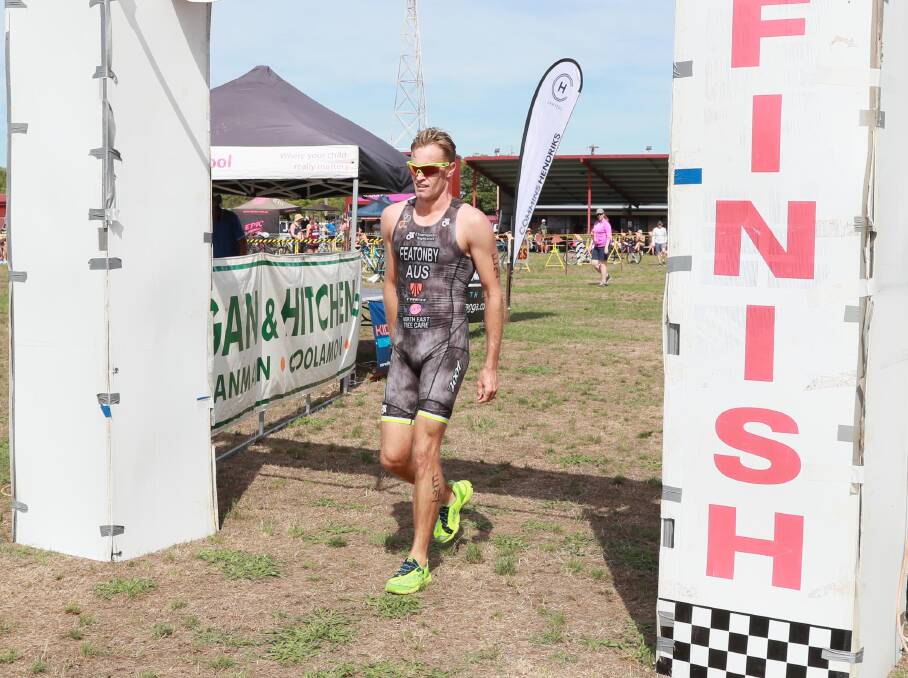 BLISTERING PACE: Albury's Jesse Featonby crosses the line in a record time to win the Ganmain Triathlon on Sunday in the first leg of the Riverina Tri Series. Picture: LES SMITH