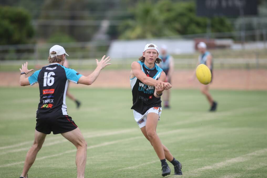 SLICK HANDS: Lavington youngster Alex Bennett fires off a handball at pre-season training for the Panthers. Picture: TARA TREWHELLA