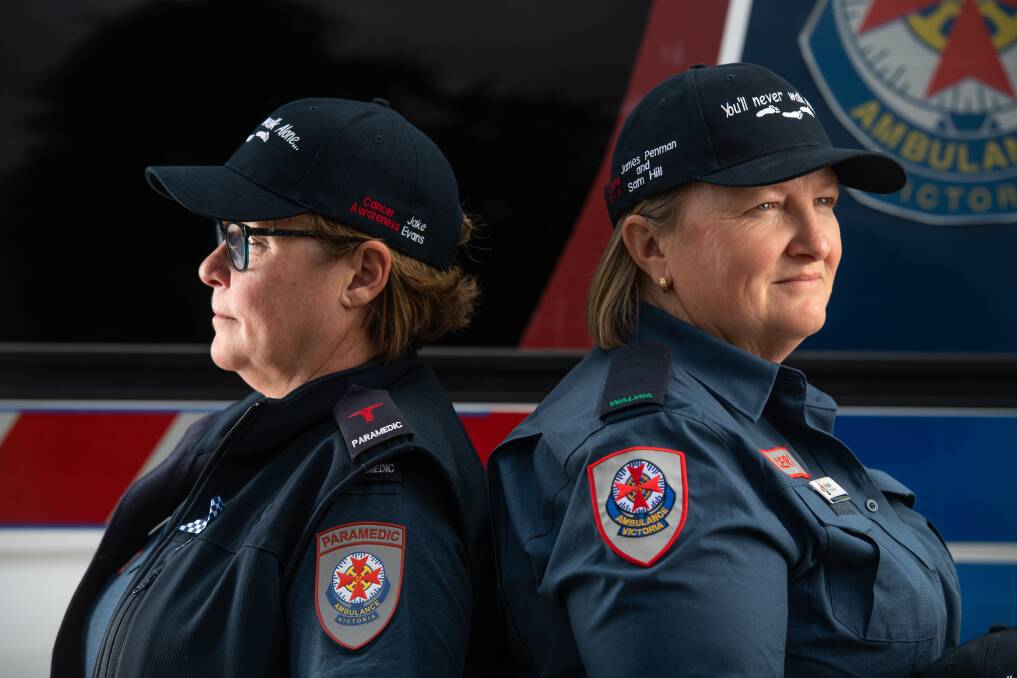 WE'RE HERE TO HELP: Ambulance Victoria paramedic Marita Harrison and community emergency response team member Meaghan Daly with the new hats, displaying the 'you'll never walk alone' message following a devastating year for the Upper Murray community. Picture: MARK JESSER