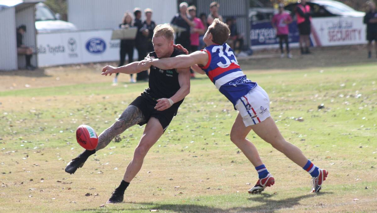 QUICK KICK: Benalla All Blacks' Jackson Hourigan gets boot to ball under pressure from Tarrawingee's Jeremy Lawford. Picture: WANGARATTA CHRONICLE