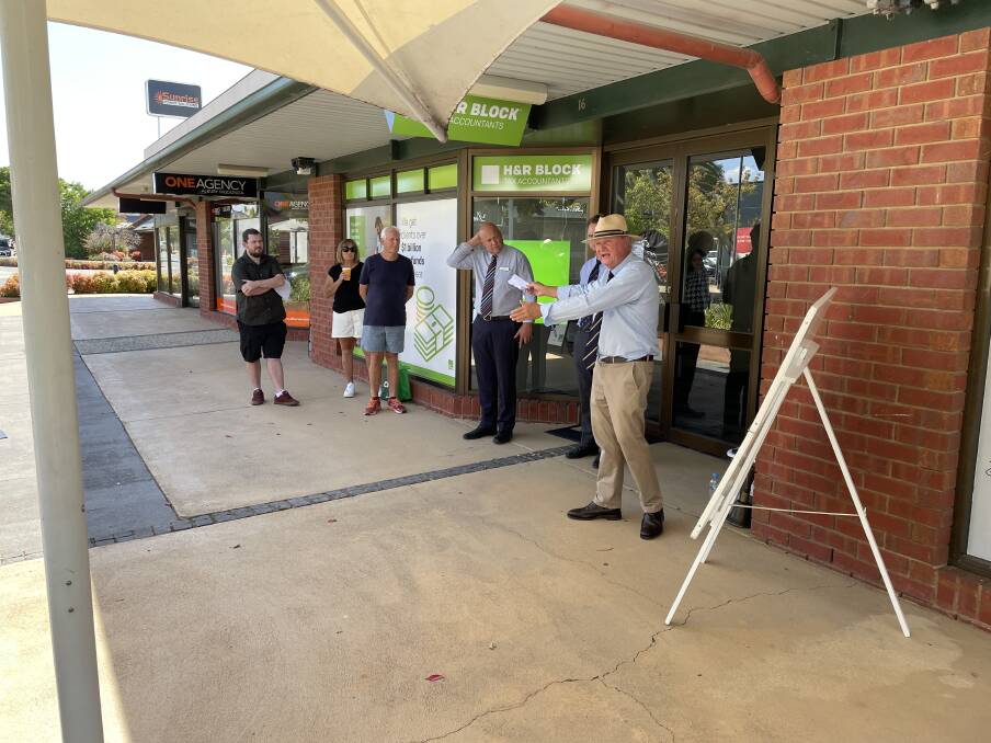Auctioneer Andrew Dixon calls for offers for the H&R Block office on Stanley Street in Wodonga on Friday, March 8. Picture by Beau Greenway