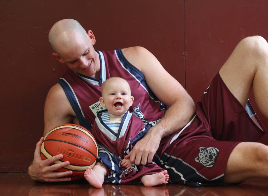 NUMBER ONE FAN: Wodonga Wolves coach Broady Mills with his six month old son, Harrison, ahead of Saturday night's CBL North East grand final.