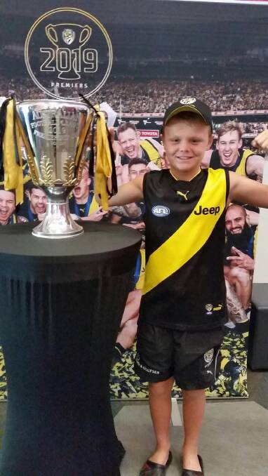 TIGER CUB: Lavington's Aden Chomatek couldn't wipe the smile off his face after getting to see Richmond's 2019 premiership cup in Albury on Wednesday.