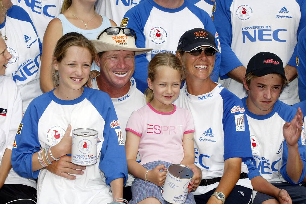 ALL SMILES: Jones with wife Jane and children, Phoebe and Isabella, during his visit to Albury as part of a fundraising walk from Sydney to Melbourne in 2003.
