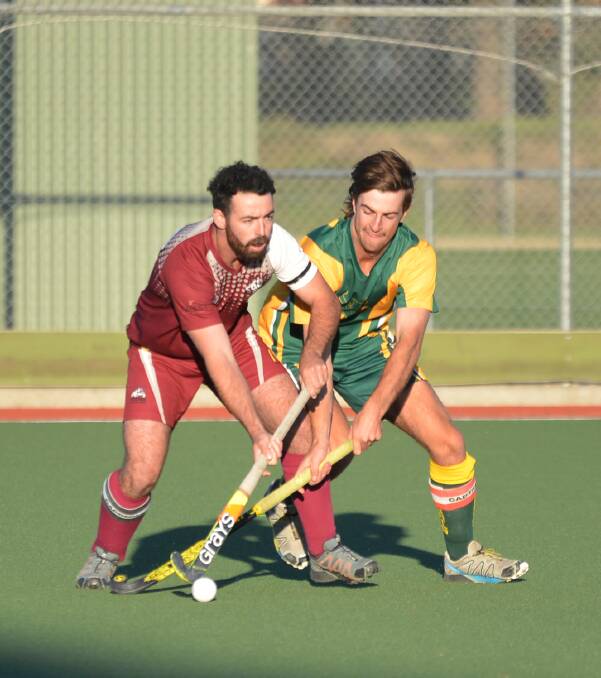 FIERCE CONTEST: Wodonga's Ethan Albon is put under huge pressure by Wombats' Thomas Kilby at Albury Hockey Centre on Sunday. Picture: NARELLE HAMILTON