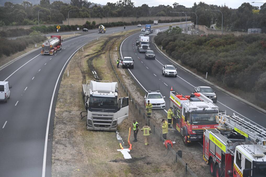 Emergency services providing assistance on the Hume Highway in Albury after a truck crashed through the safety barrier on Tuesday morning. Picture by Mark Jesser