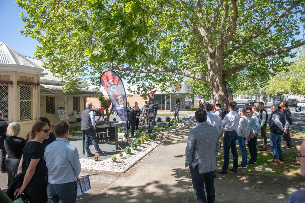 A large crowd gathered for the auction of a central Albury office on the corner of Swift and Macauley streets, which sold for $820,000 on Friday, October 6. Picture by Tara Trewhella